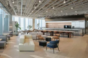 Modern office interior with seating areas and a kitchen