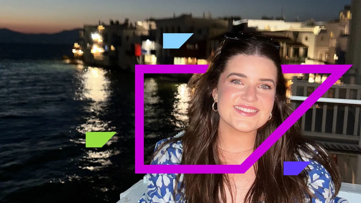 A woman smiling by the water at sunset with colorful geometric shapes overlay