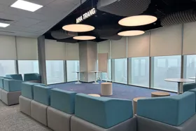 Modern lounge area with blue and gray seating and large windows