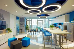 Modern kitchen and dining area with blue accents and circular light fixtures