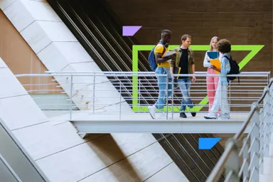 Group of students talking on a bridge in a modern building