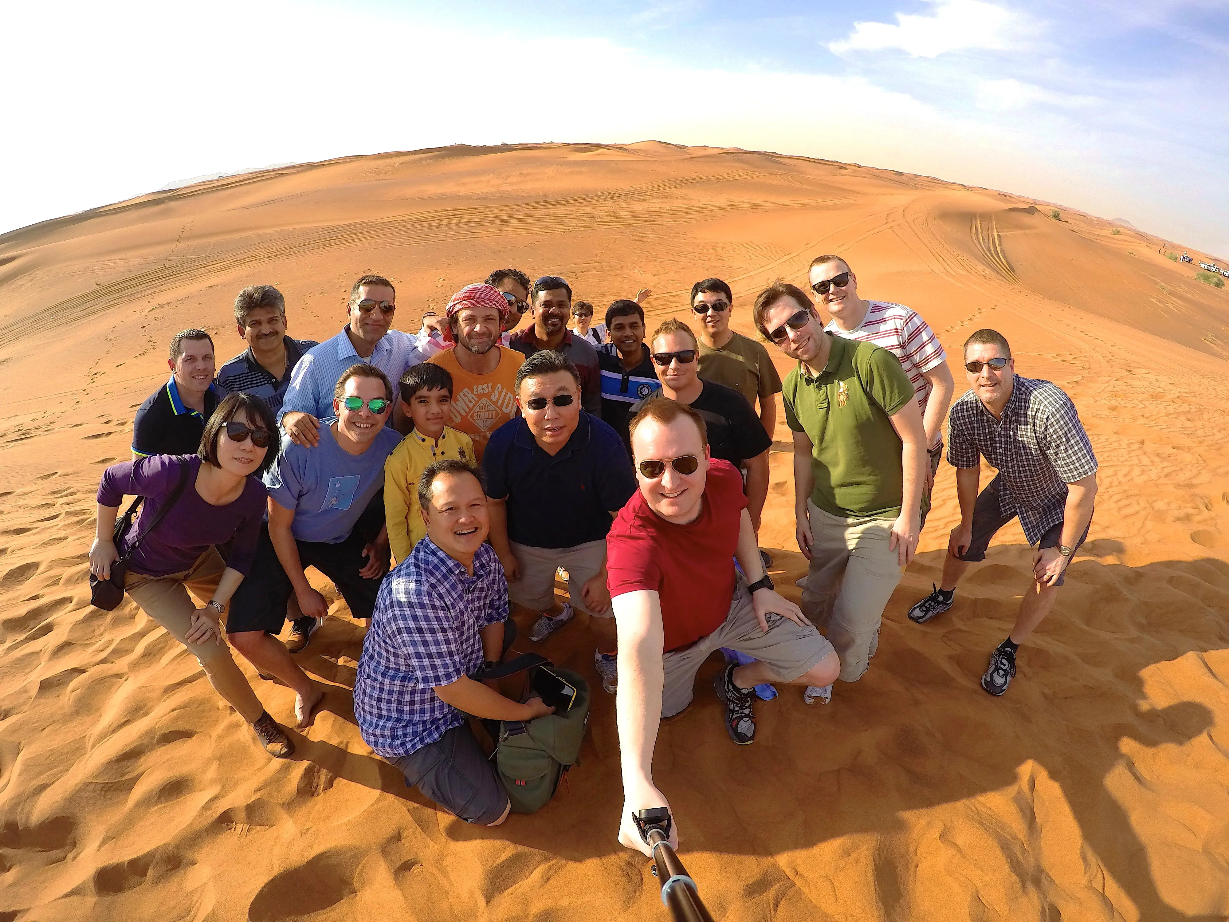 Stephen and his management team take a group photo in the Dubai desert.